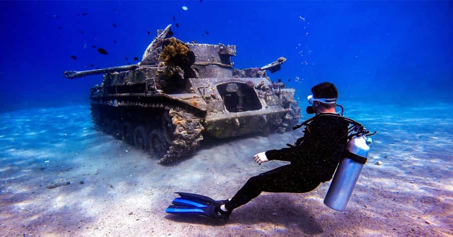 Aqaba Dive Adventure: Explore The Red Sea On A Tour - What you see underwater: coral reefs, fish, wreck structures, and a tank
