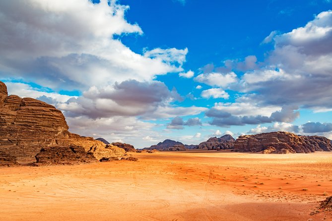 Private Full-Day Wadi Rum and Petra Tour from Aqaba - Wadi Rum on a 4x4: pink cliffs, rock carvings, and Bedouin tea